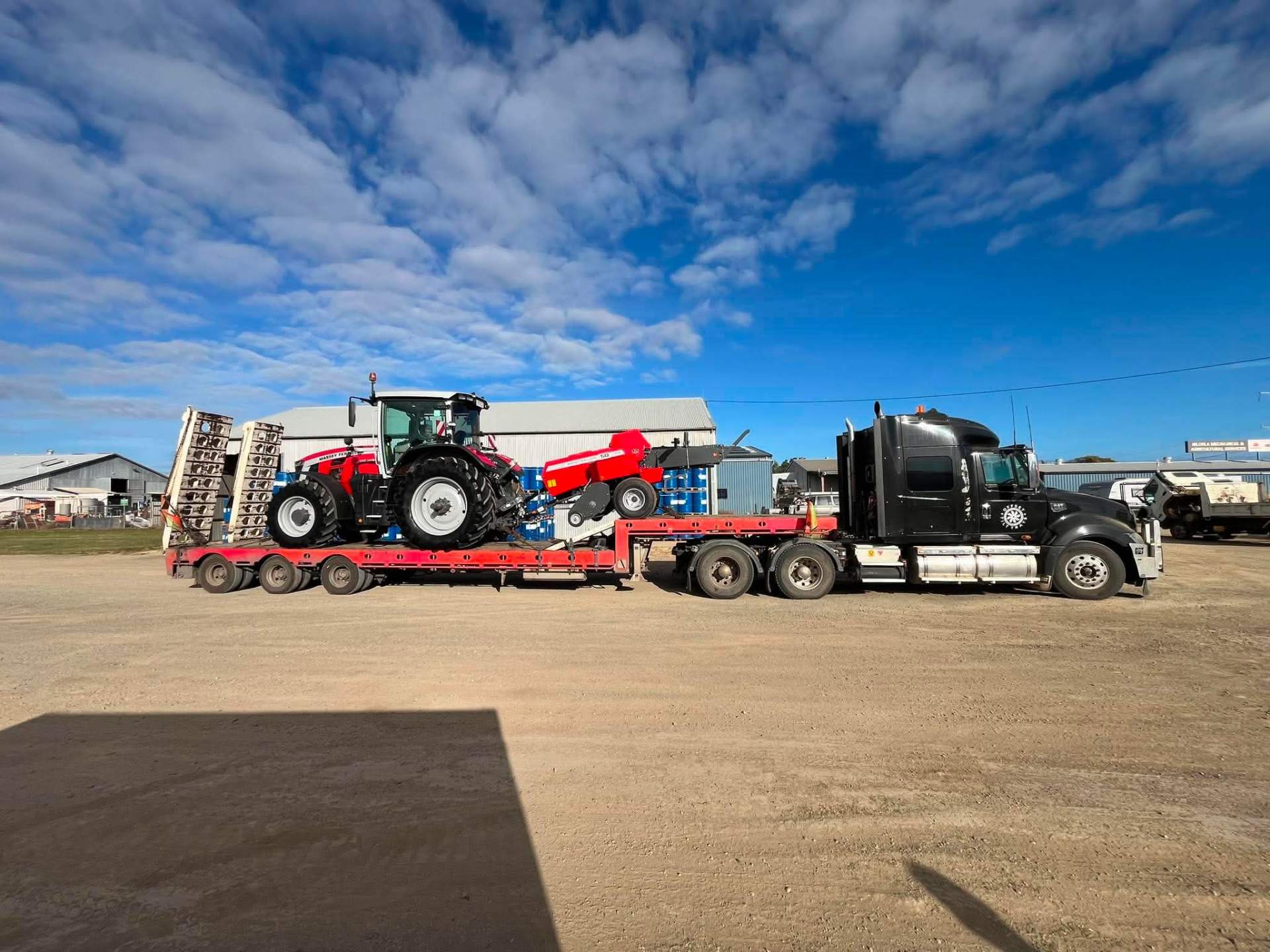 Tilt tray truck transporting heavy equipment in Rockhampton