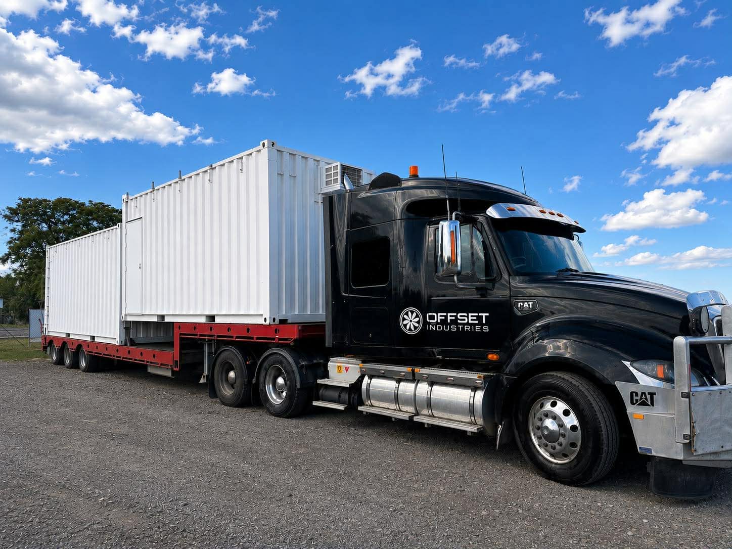 Offset Industries tilt tray truck on a Rockhampton road
