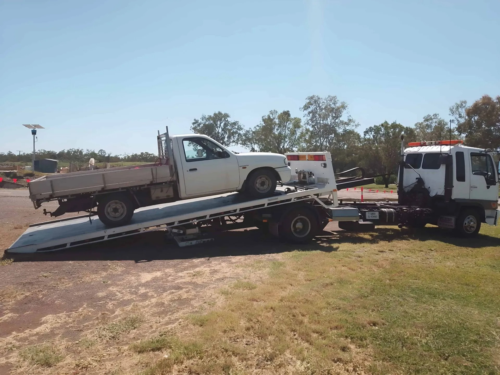 Vehicle being loaded onto a tilt tray truck in Rockhampton